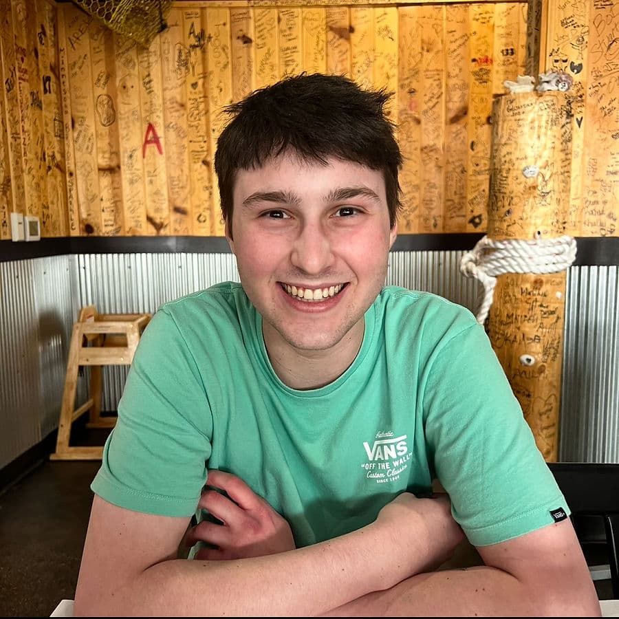 Jack, smiling warmly in a green shirt